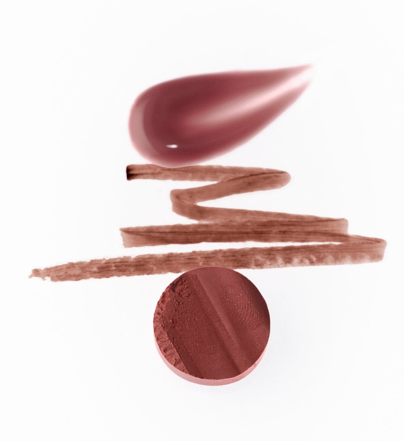 A blush swatch, lip pencil strokes and a rosy compact